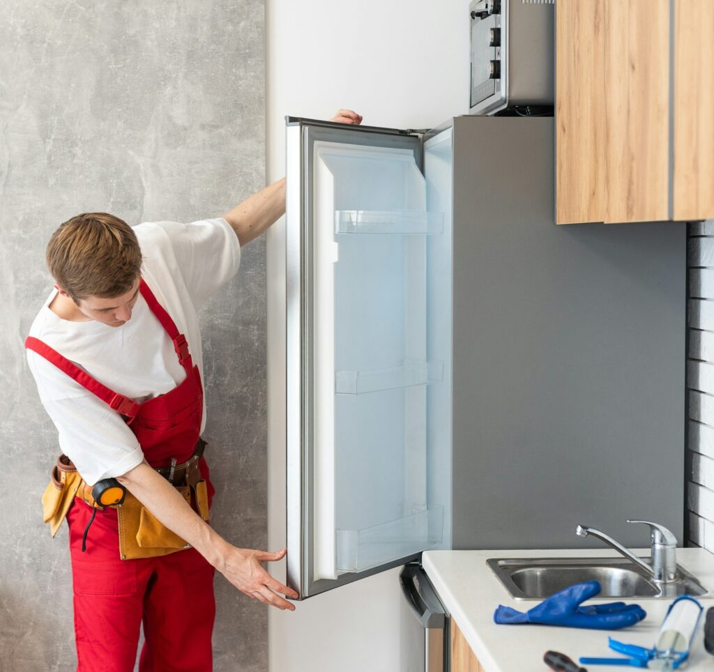 Electrician Technician Working To Repair Refrigerator Or Fridge Appliance